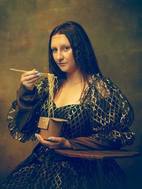 Young woman as Mona Lisa, La Gioconda isolated on dark green