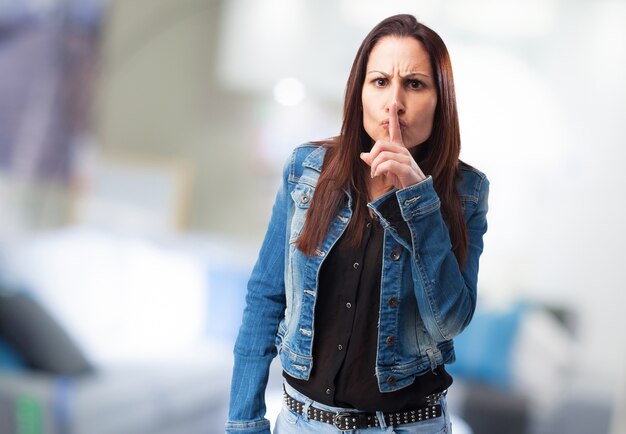 Young woman asking for silence