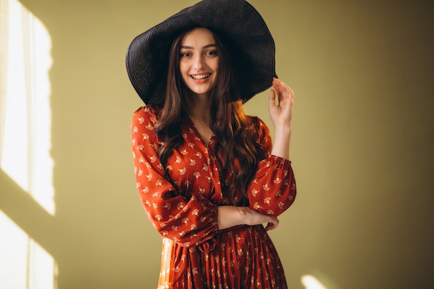 Young woman in a beautiful dress and hat