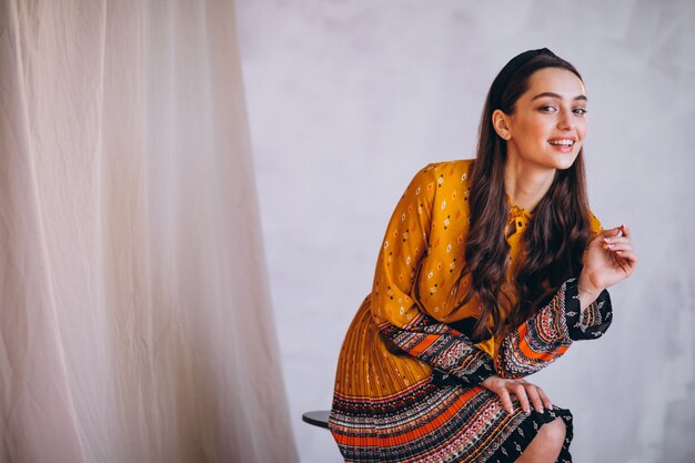 Young woman in a beautiful yellow dress