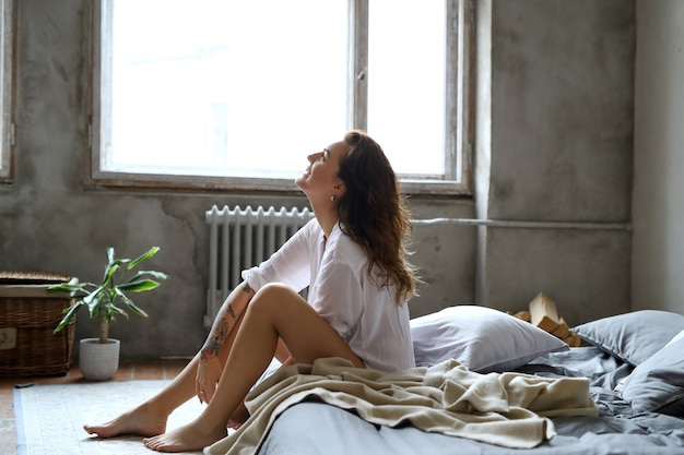 Young woman in bed at morning
