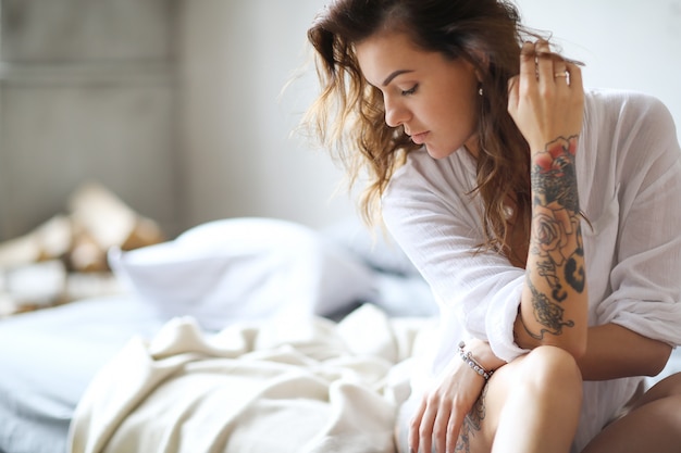 Young woman in bed at morning