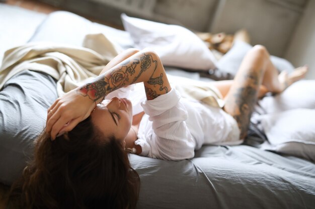 Young woman in bed at morning