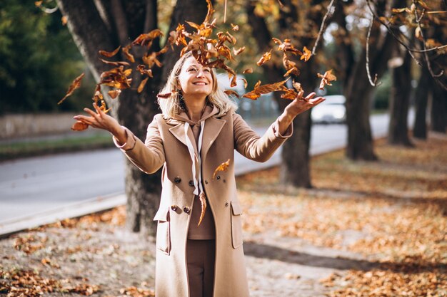 Young woman in beige suit outside in an autumn park