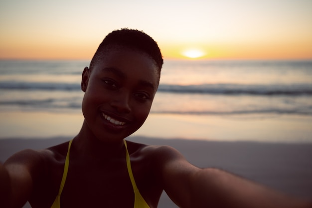 Young woman in bikini standing on the beach