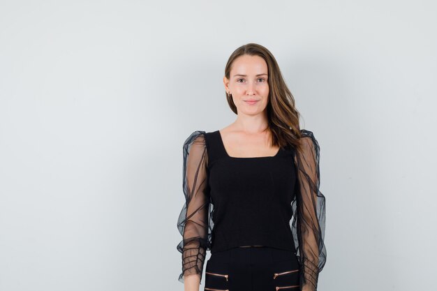 Young woman in black blouse looking at camera and looking nice 