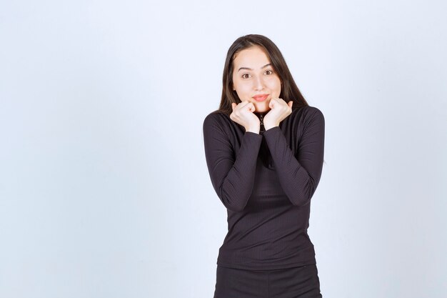 Young woman in black clothes giving lovely poses