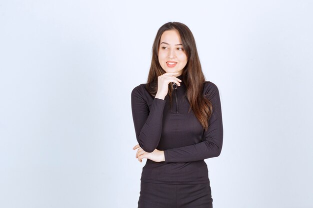 Young woman in black clothes looks professional and confident