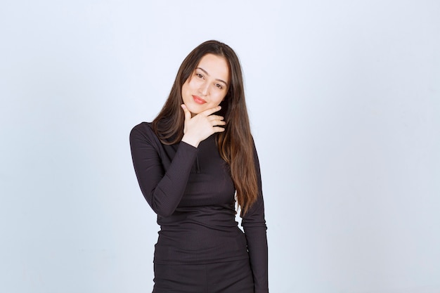 Young woman in black clothes looks professional and confident