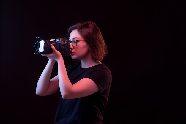 Young woman in black t-shirt with camera