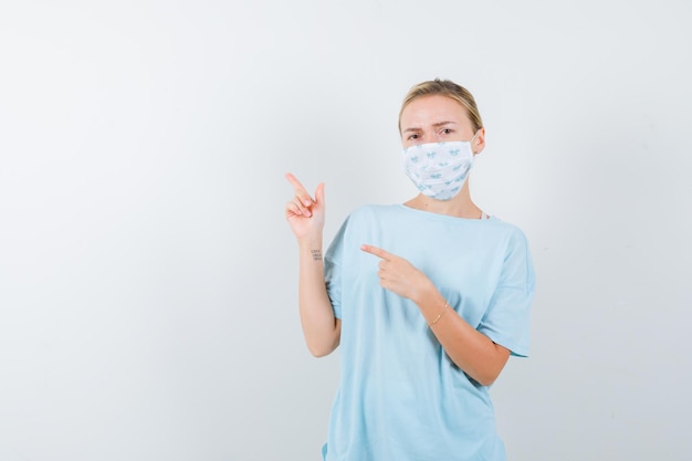 Young woman in a blue t-shirt with a medical mask