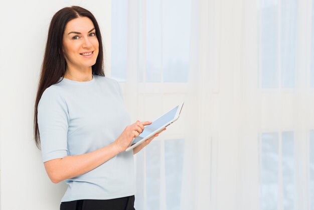 Young woman in blue using tablet