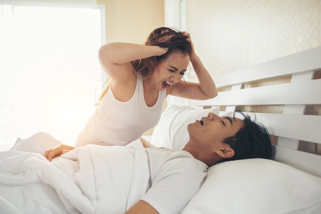 Young woman bored with her boyfriend snoring