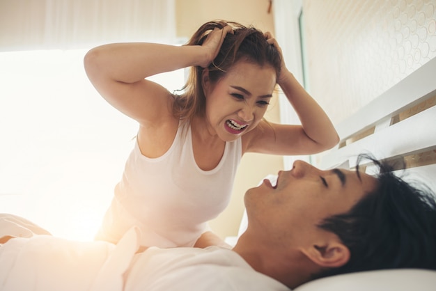 Young woman bored with her boyfriend snoring