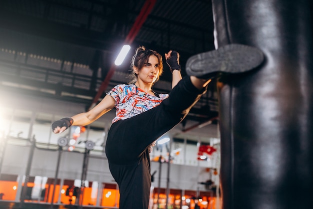 Young woman boxer training at the gym