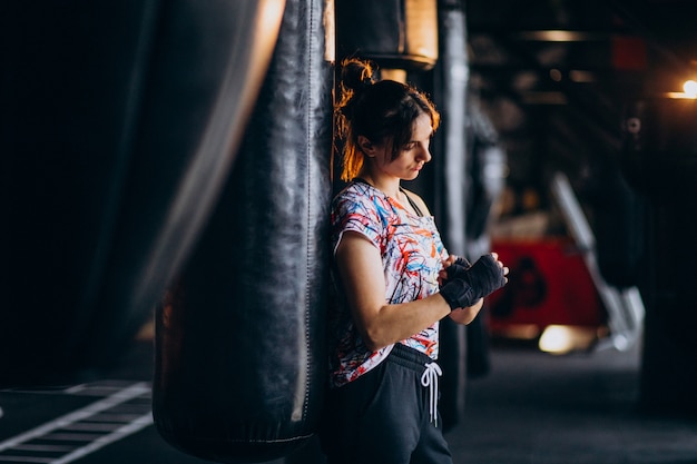 Young woman boxer training at the gym