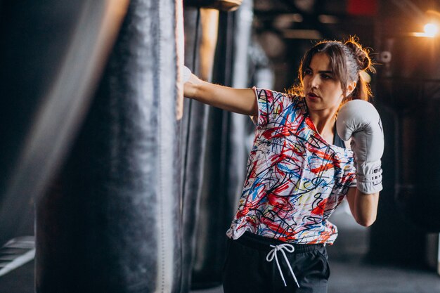 Young woman boxer training at the gym