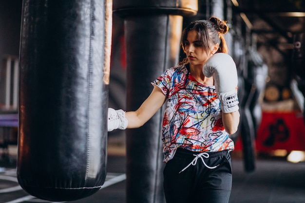 Young woman boxer training at the gym