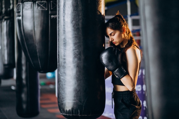 Young woman boxer training at the gym