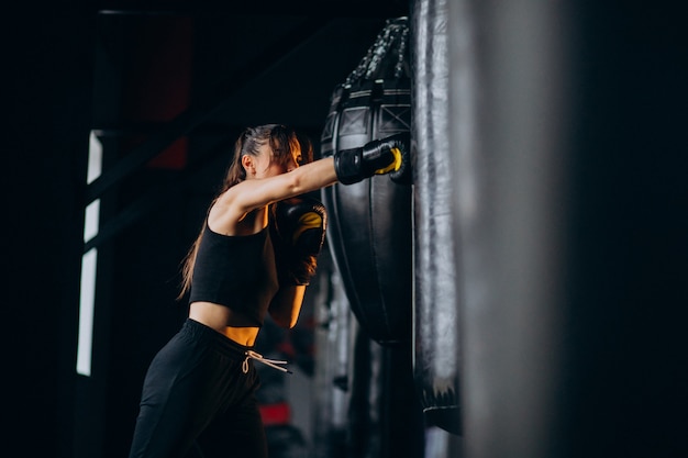 Young woman boxer training at the gym