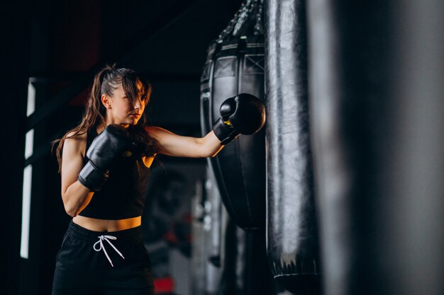 Young woman boxer training at the gym