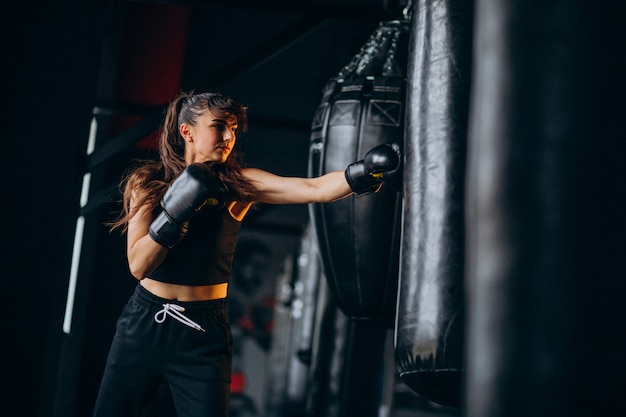 Free photo young woman boxer training at the gym