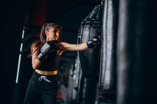 Young woman boxer training at the gym