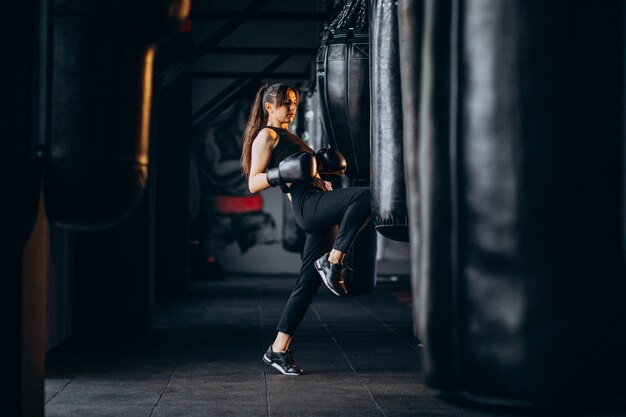 Young woman boxer training at the gym