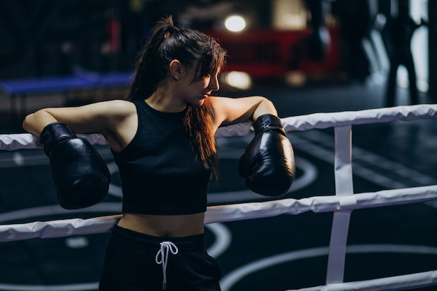 Free photo young woman boxer training at the gym