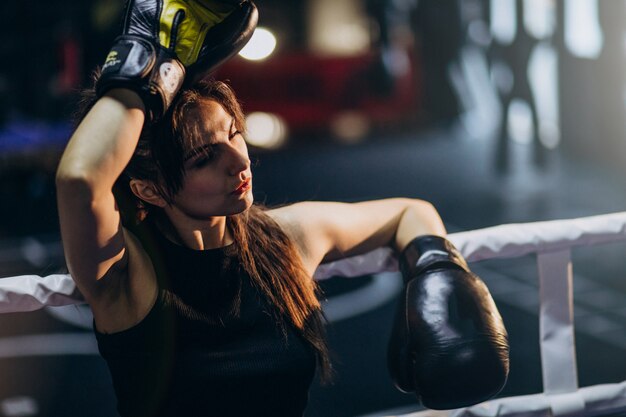 Young woman boxer training at the gym