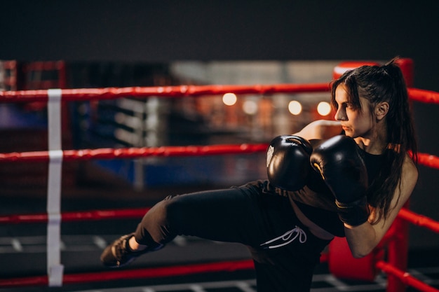 Young woman boxer training at the gym