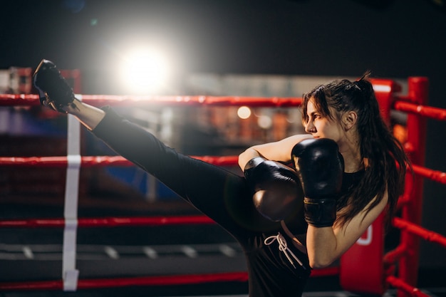 Free photo young woman boxer training at the gym