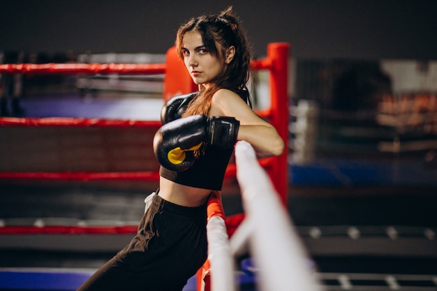 Free photo young woman boxer training at the gym