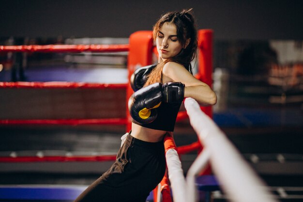 Free photo young woman boxer training at the gym
