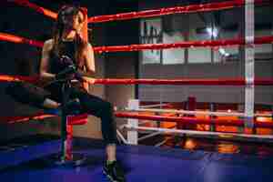 Free photo young woman boxer training at the gym