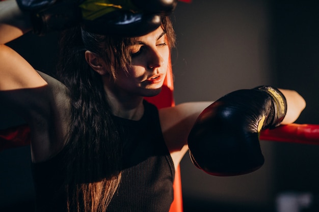 Free photo young woman boxer training at the gym