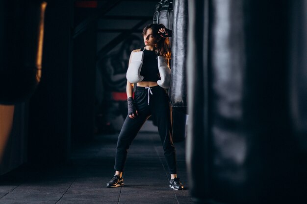 Young woman boxer training at the gym