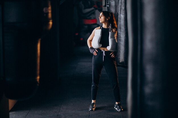 Young woman boxer training at the gym