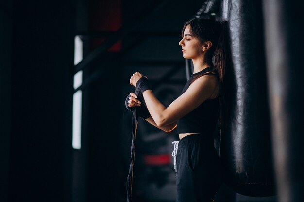 Young woman boxer training at the gym