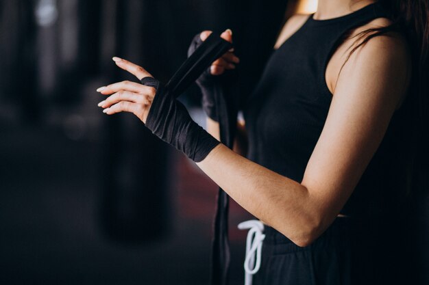 Young woman boxer training at the gym