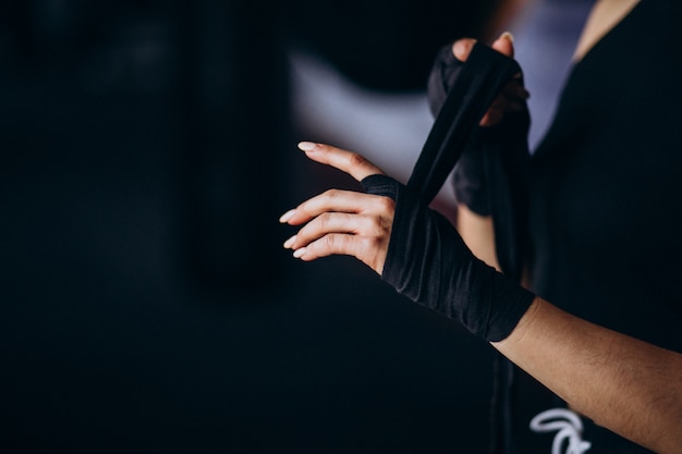 Young woman boxer training at the gym