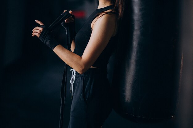 Young woman boxer training at the gym