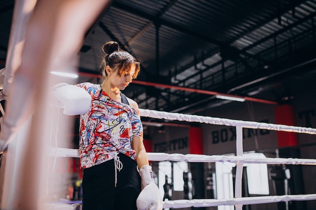 Young woman boxer training at the gym