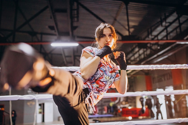 Young woman boxer training at the gym