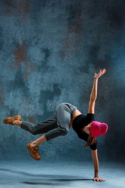 Young woman break dancing.