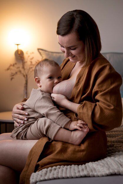 Young woman breastfeeding her cute baby