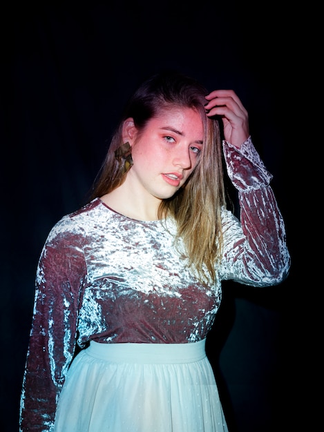 Free photo young woman in bright dress looking at camera