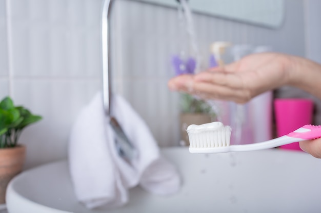 Young woman brushing teeth.