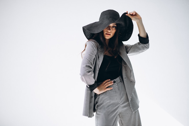 Free Photo young woman in a business suit wearing a hat