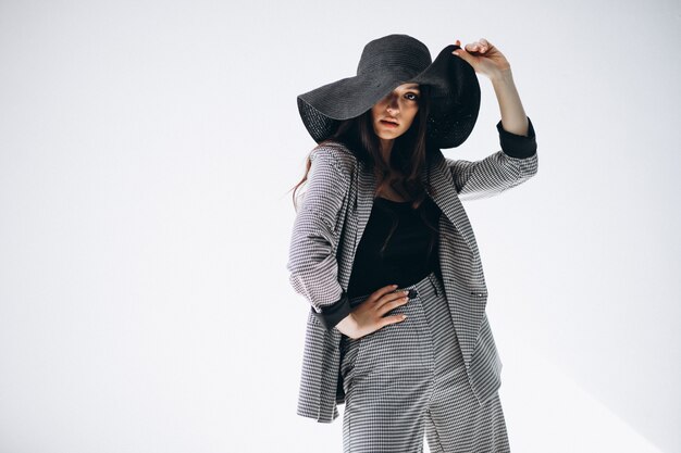 一位身著商務服,戴著帽子的年輕女人